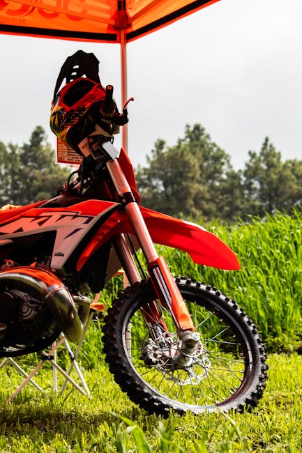 A vivid motorcycle parked under a tent, ideal for motocross adventures in Mexico.